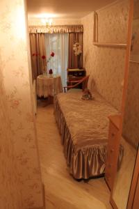 a bedroom with a bed and a table and a mirror at Apartment Auseklis in Rīga
