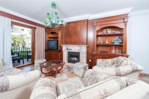 a living room with two couches and a fireplace at Can Barret in Can Picafort