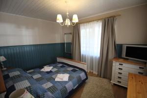 a bedroom with a bed and a television in it at Villa Dirhami in Dirhami