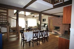 a dining room with a table and chairs and a fireplace at Villa Dirhami in Dirhami