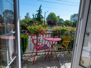 un patio con mesa, sillas y flores en Gîte Étain, 4 pièces, 6 personnes - FR-1-585-57, en Étain