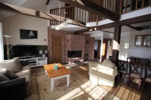 a living room with a couch and a fireplace at Villa Dirhami in Dirhami