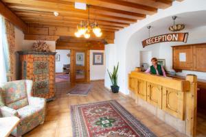 a woman standing at a counter in a living room at Sporthotel Flachauwinkl in Flachau