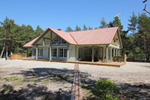 a small house with a red roof at Villa Dirhami in Dirhami