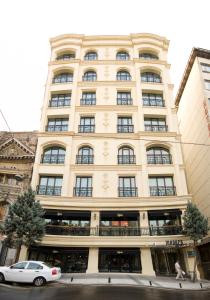 a large building with a car parked in front of it at Innpera Hotel in Istanbul