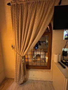 a curtain in a room with a window at Kasri Mezopotamya in Midyat