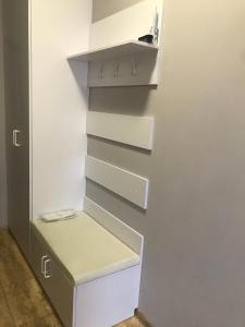 a closet with white drawers and a shelf at Apart Assistant on Smart Plaza in Kyiv