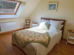 a bedroom with a large bed and a window at Maison spacieuse avec jardin, terrasse et tout confort, calme assuré à Poinville - FR-1-581-16 in Poinville