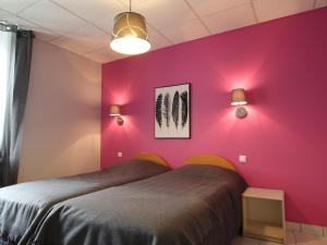 a bedroom with pink walls and a bed at Gîte Saint-Julien-Molhesabate, 4 pièces, 6 personnes - FR-1-582-265 in Saint-Julien-Molhesabate