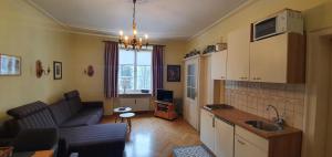 a kitchen and living room with a couch and a table at Ferienappartement Königliche Villa Berchtesgaden in Berchtesgaden