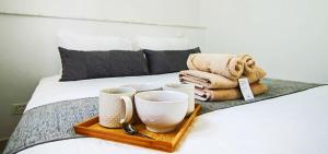 a tray with cups and towels on a bed at Phaedrus Living - Seaside Executive Flat Harbour 205 in Paphos