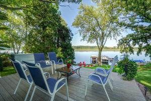 een terras met stoelen en een tafel met uitzicht op een meer bij Blue Fish Cottage in Waterford