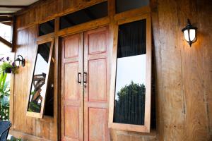 a wooden door on a house with a window at Samami Garden in Bandung