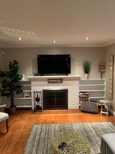 a living room with a fireplace with a flat screen tv at Arlington, VA for Lovers and Friends in Arlington