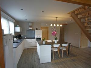 a kitchen with a table and some chairs in it at Gîte Chamagne, 3 pièces, 4 personnes - FR-1-589-11 