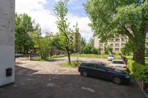 a car parked in a parking lot in front of a building at Avitar in Rīga