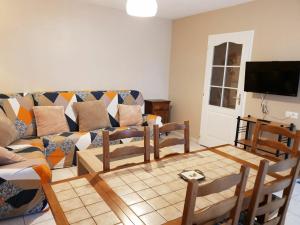 a living room with a couch and a table at Charmant apt avec accès indépendant, terrasse, proche Épinal et activités culturelles - FR-1-589-138 in Hagécourt