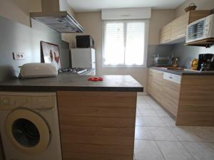 a kitchen with a washing machine on a counter at Charmant apt avec accès indépendant, terrasse, proche Épinal et activités culturelles - FR-1-589-138 in Hagécourt +8 photos