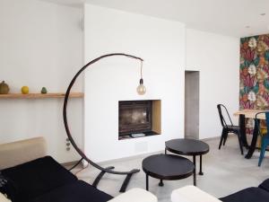 a living room with a couch and chairs and a fireplace at Gîte d'Architecte 6 Pers. avec Terrasse et Jardin à Pissotte - FR-1-426-480 in Pissotte