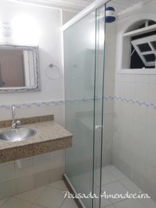 a bathroom with a shower and a sink at POUSADA AMENDOEIRA in Búzios