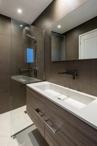 a bathroom with a sink and a mirror at Executive 2 bdr Suite in Plaka - Acropolis view in Athens