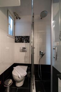 a bathroom with a toilet and a shower at An adorable Apartment in Athens in Athens