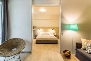 アテネにあるOne-Bedroom Apartment - Kolonakiのベッドルーム1室(ベッド1台、椅子、ソファ付)