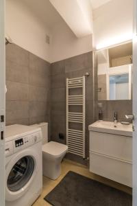 a bathroom with a washing machine and a sink at Superb apartment in the heart of Athens in Athens