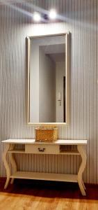 a mirror on top of a white table in a room at Mokka Apartament in Kielce