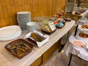 ein Buffet mit Tellern und Körben von Speisen in der Unterkunft HOTEL FESTA BRAVA in Andorra la Vella