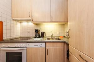 a small kitchen with a sink and a stove at Ferienwohnung Allegra in Reit im Winkl