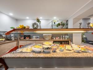 a buffet line with many different types of food at Cityhotel Bernburg in Bernburg