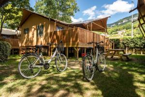 two bikes parked in front of a house at Camping maeva Escapades Millau Plage in Millau