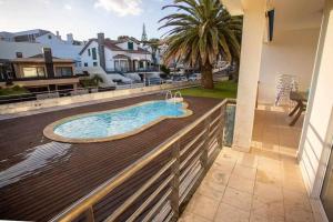 a swimming pool on the deck of a house at Marina de Vila Franca do Campo in Vila Franca do Campo