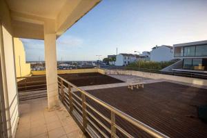 a balcony with a bench on top of a building at Marina de Vila Franca do Campo in Vila Franca do Campo