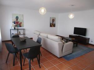 a living room with a couch and a table at The Artist´s Apartment in Espinho
