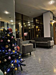 a christmas tree in the lobby of a hotel at Park Hotel Fili in Moscow