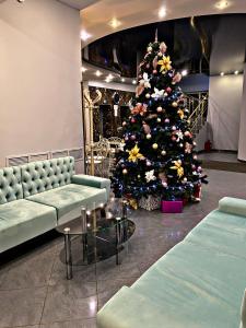 a christmas tree in a room with a christmas tree at Park Hotel Fili in Moscow