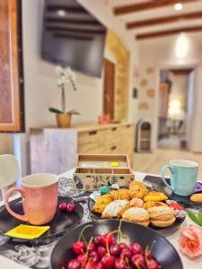 a table with two plates of food and two cups at Borro Palace in Cagliari