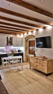 a kitchen with a table and a tv on the wall at Borro Palace in Cagliari