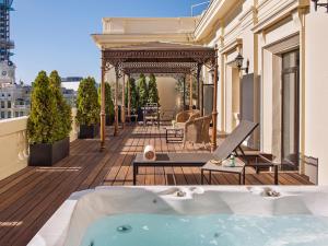 a patio area with a pool table and chairs at Hotel Fenix Gran Meliá - The Leading Hotels of the World in Madrid