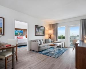 a living room with a couch and a table at Compass Hotel by Margaritaville Anna Maria Sound in Bradenton +26 photos