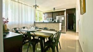 a kitchen and dining room with a table and chairs at Nice Apartment in Santiago, Near Popular Places in Santiago de los Caballeros