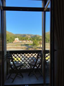 a balcony with two chairs and a view of the mountains at Apartamento Casa Anselmo La cambra 