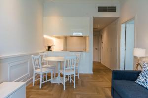 a kitchen and living room with a table and chairs at Boulevard - Lisbon Landmark Apartment by Innkeeper in Lisbon