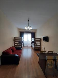 a living room with a couch and a table at New Gudauri Apartment in Gudauri