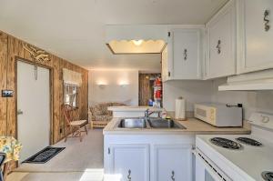 a kitchen with white cabinets and a sink at Pet-Friendly Cabin with Dock Fish and Explore! in Oriental +16 photos