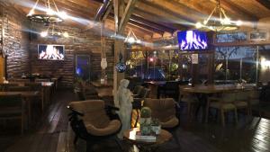 a restaurant with a bar with tables and chairs at Line Suite Hotel in Kırklareli