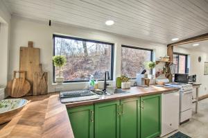 a kitchen with green cabinets and a large window at Nellysford Home about 10 Mi to Wintergreen Resort in Nellysford