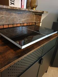 a glass counter top with books on top of it at Suite privé dans maison de village in Soual